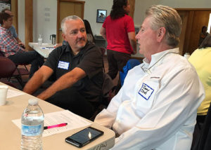 Scott Colton, Corporate CFO, and Dean Hendrix, IRM Director, chat during a break.